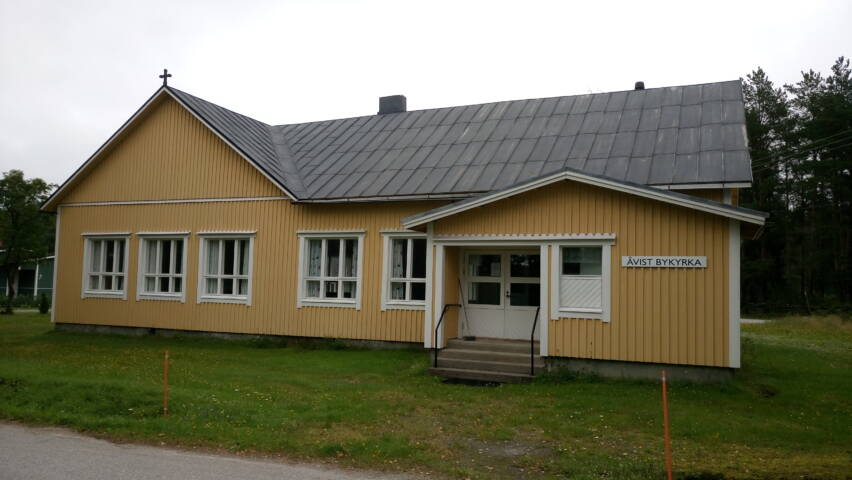 Åvist bykyrka, gult trähus.